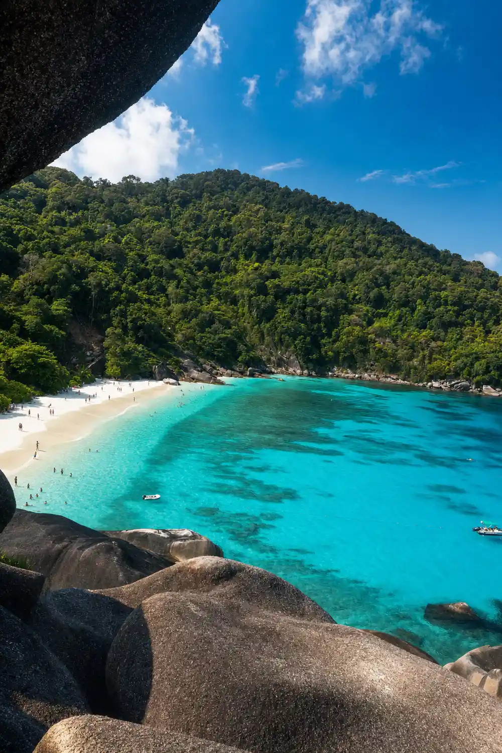 Curved white beach with turquoise water and granite rocks