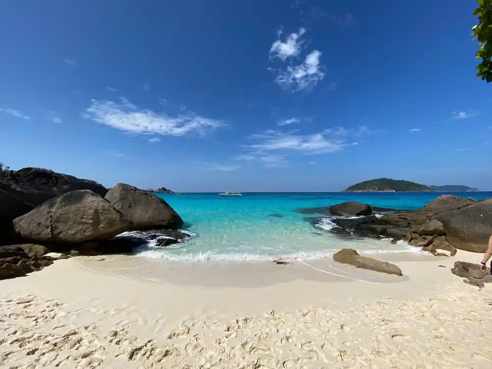 Granite boulders on sandy beach with turquoise water