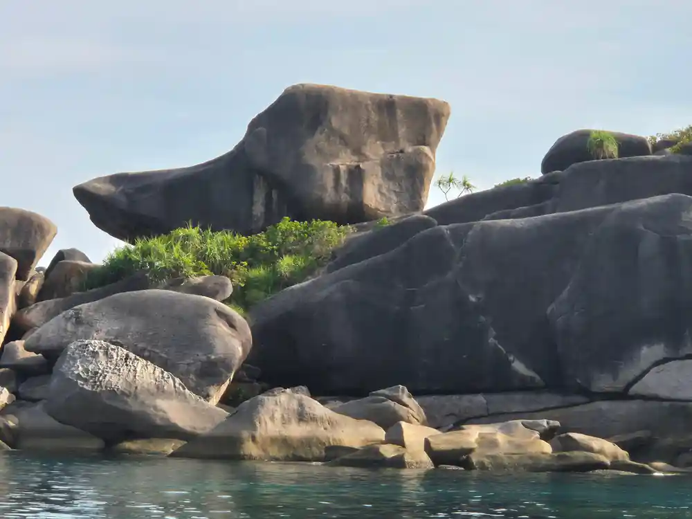 Massive sculptured granite boulders rising from water