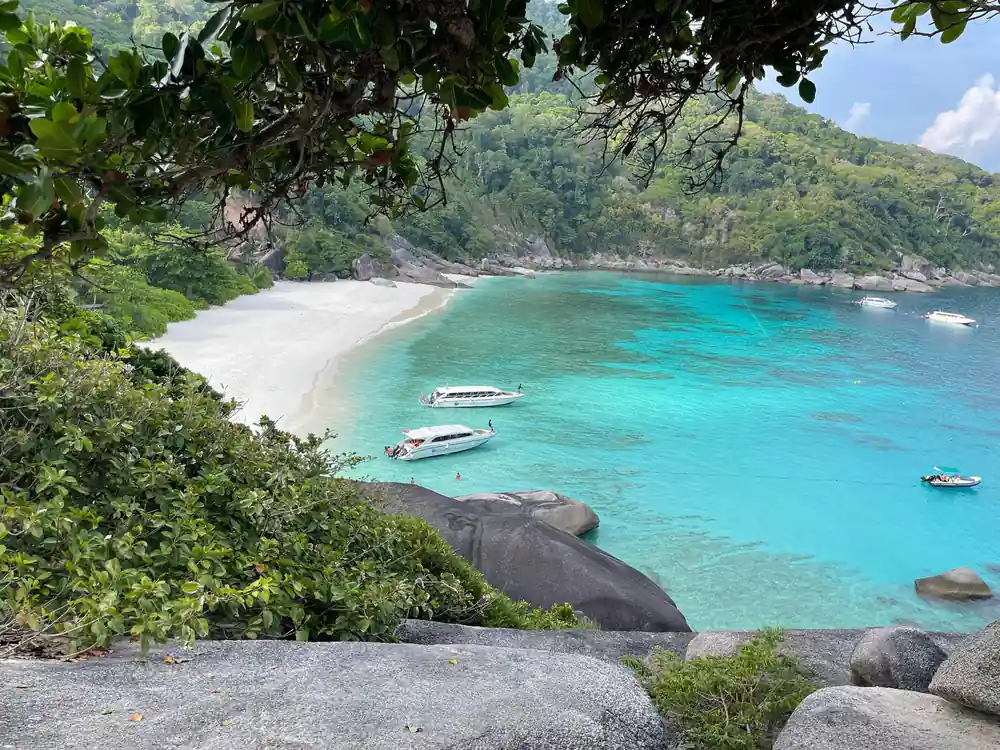 Turquoise bay with white sand beach and granite boulders